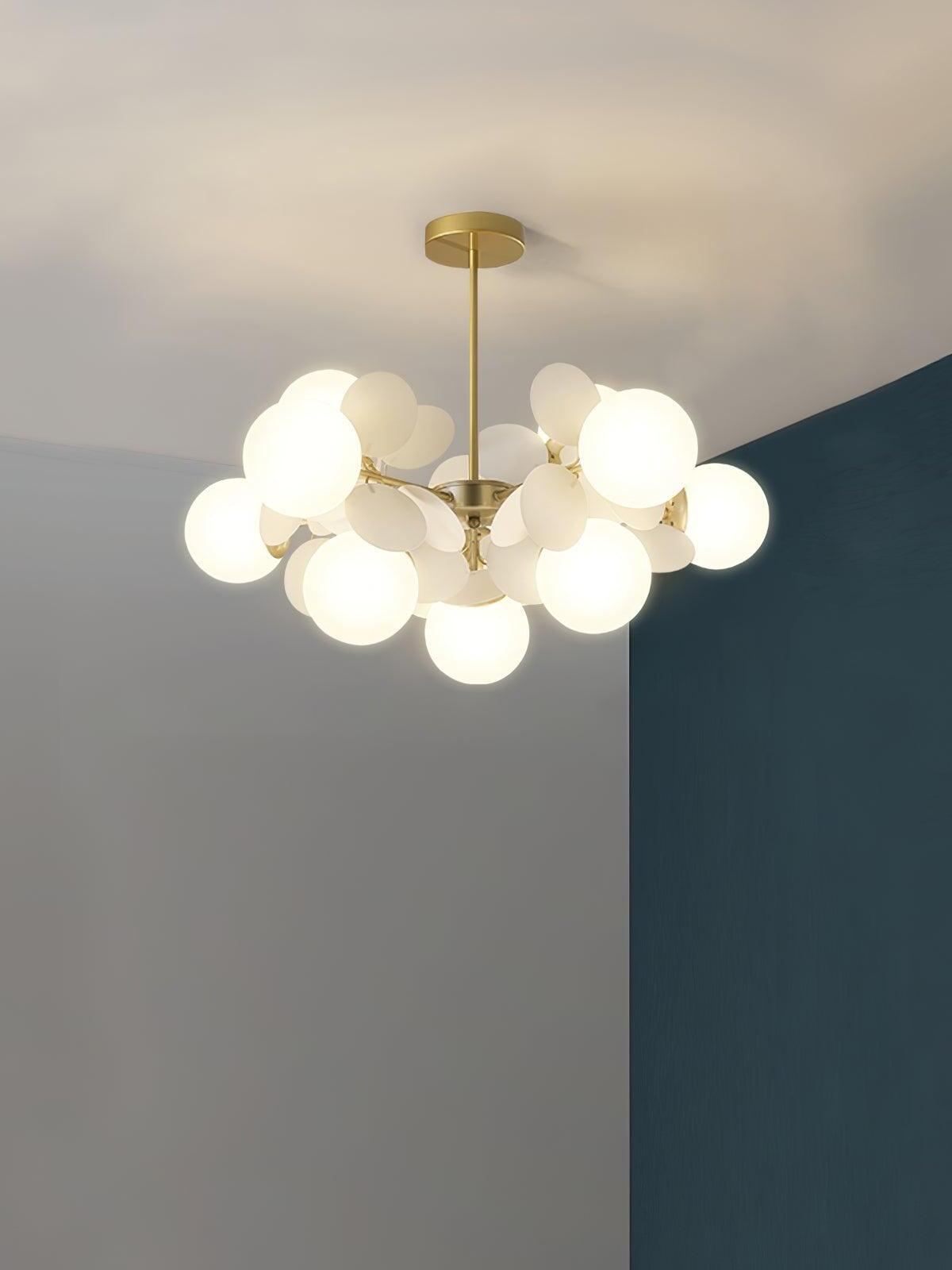 Gold chandelier with ten white globes and pale rounded discs