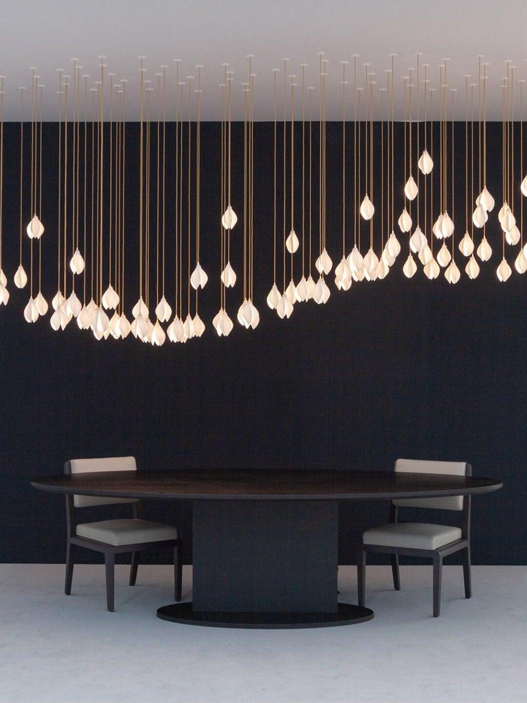 Long row of petal lights over a dining table