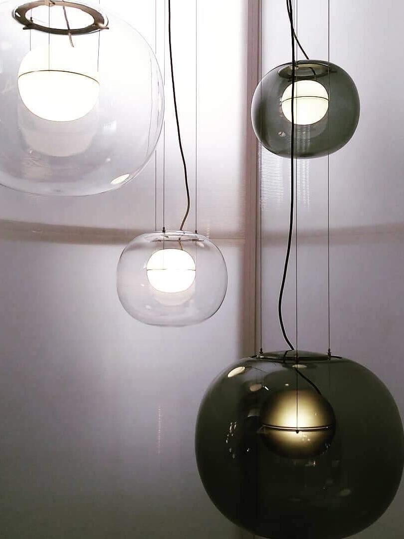 Clear and dark glass pendants hanging at varied heights