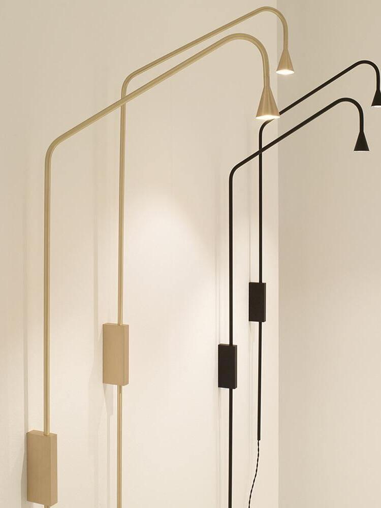Black and Golden slender wall lights in a row