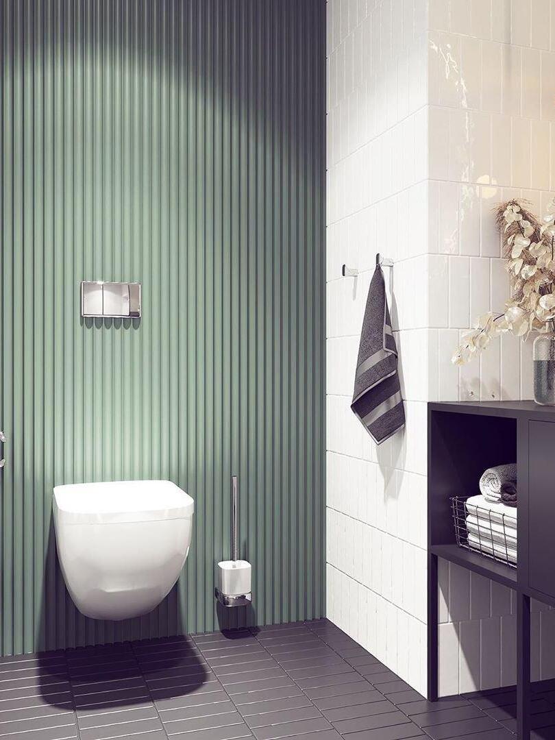 Bathroom with green ribbed wall panel, tiled wall, toilet and dark vanity