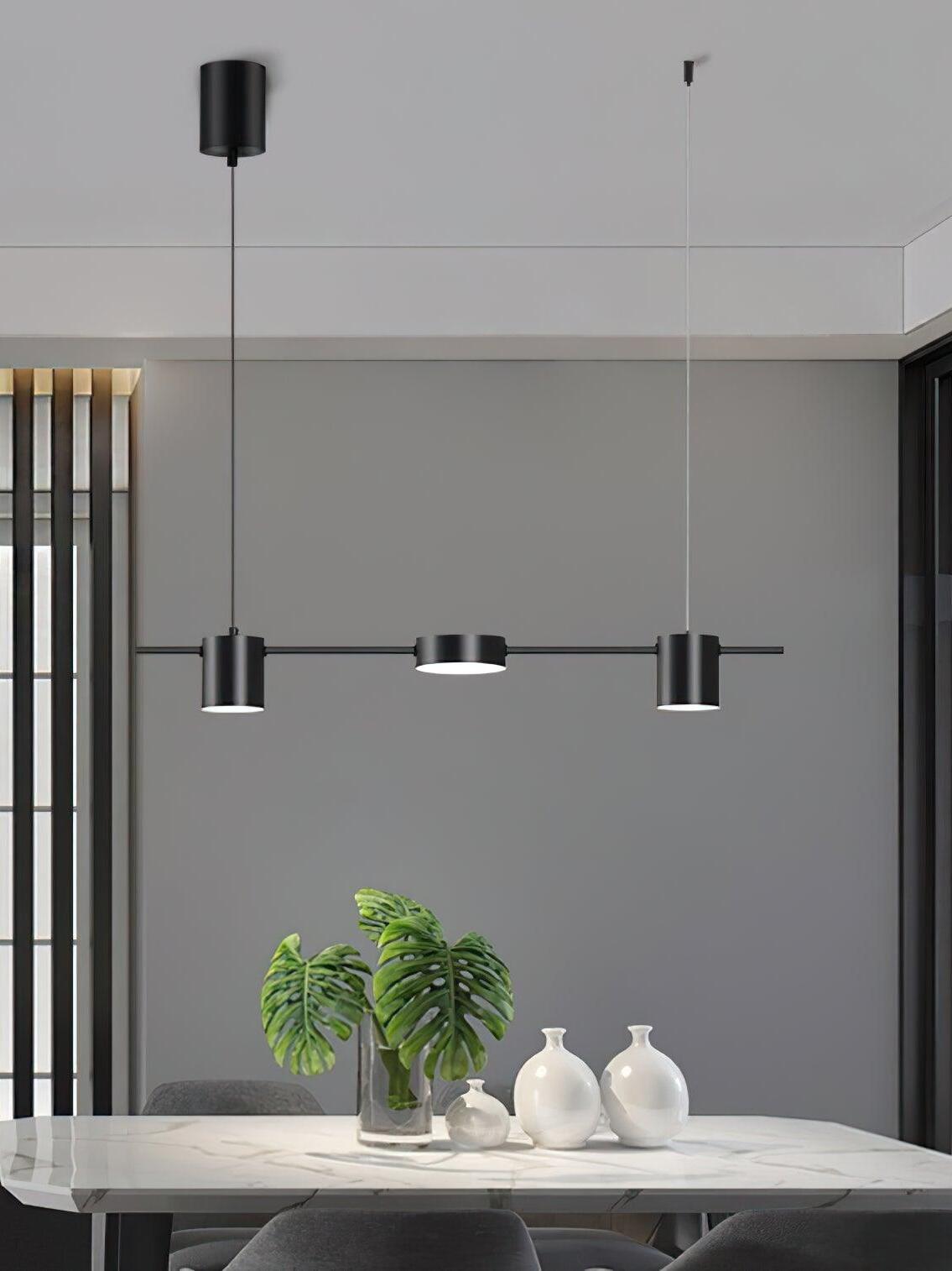 Short black linear pendant above a light-coloured table