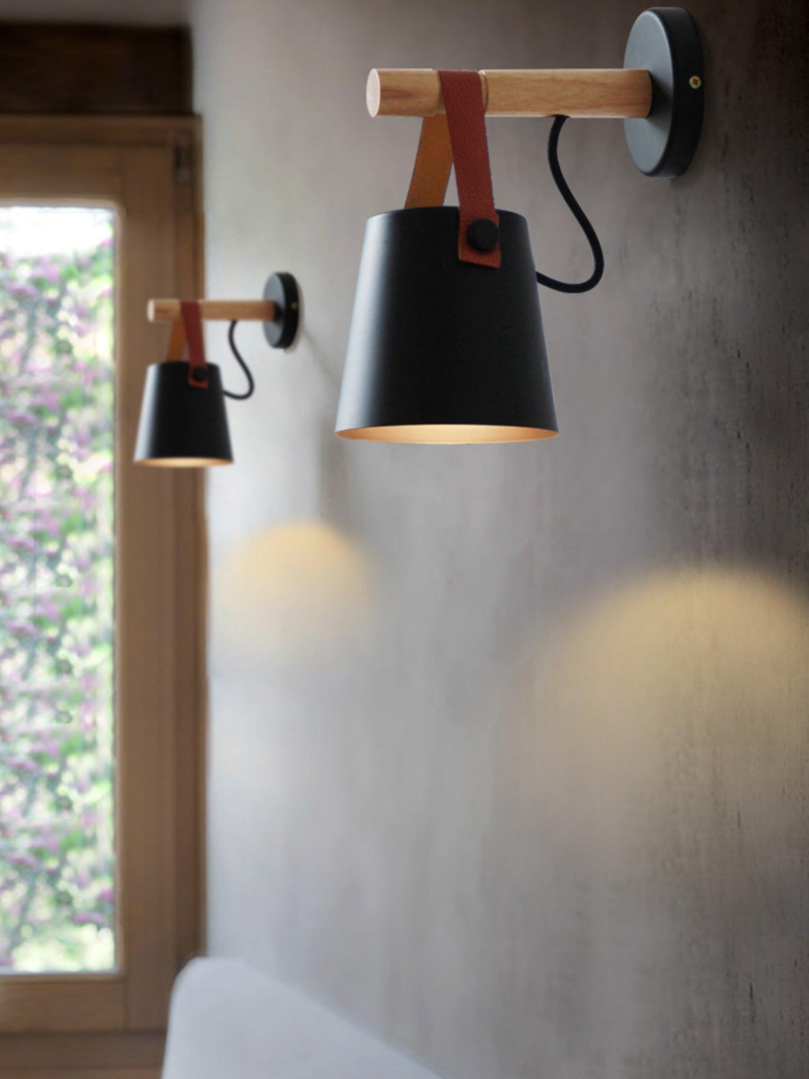 Multiple Black hanging-shade fixtures along an indoor wall