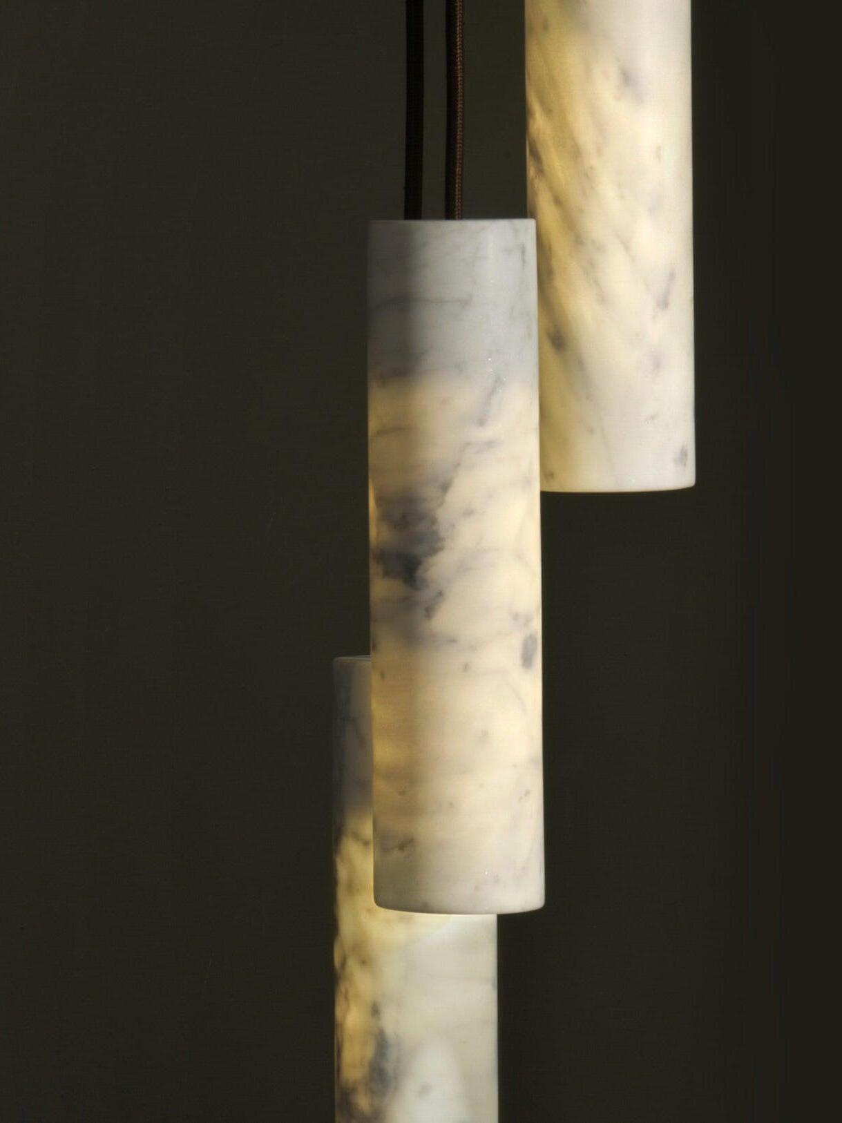 Close-up of Silo cylinders with illuminated areas and grey veining in the pale stone