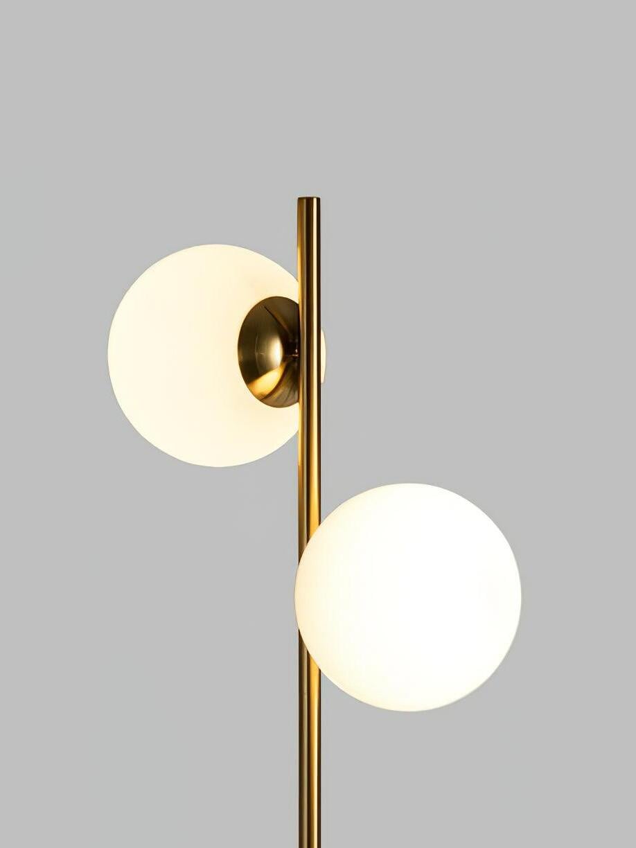 Two white globes at different heights on gold stem