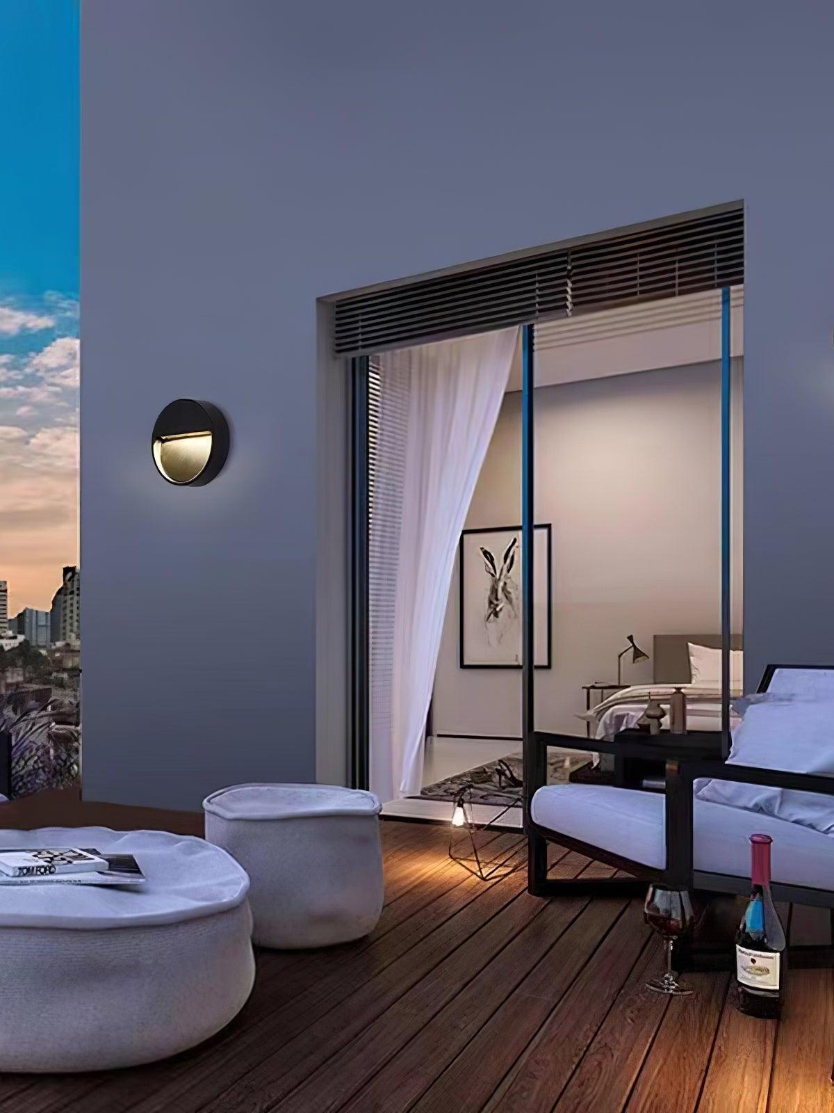 Round black lamp on balcony-side exterior wall