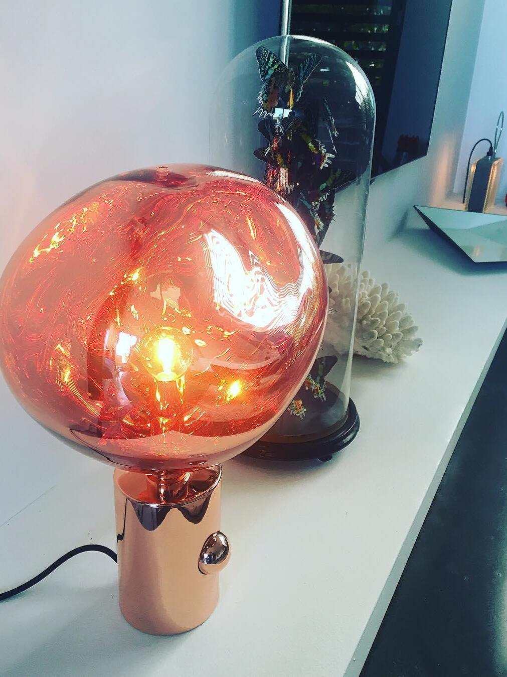 Illuminated irregular shade on a polished base
