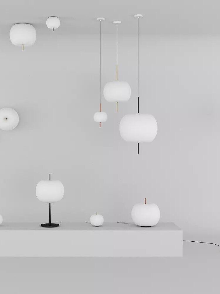 Gallery display of white glass pendant, wall and table fixtures