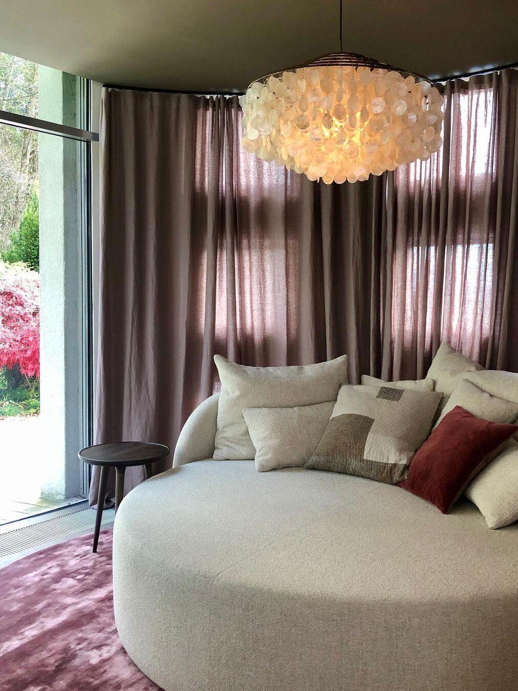 Glowing shell fixture over a curved sofa