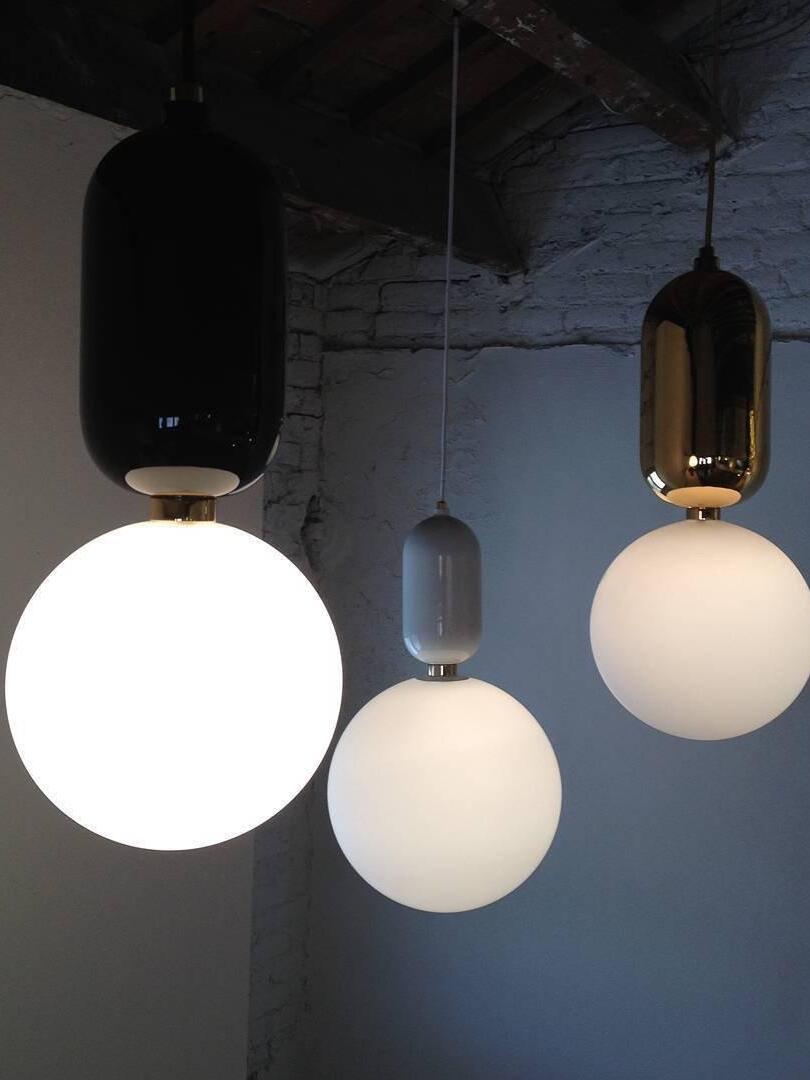 Three white globes with differently coloured rounded caps