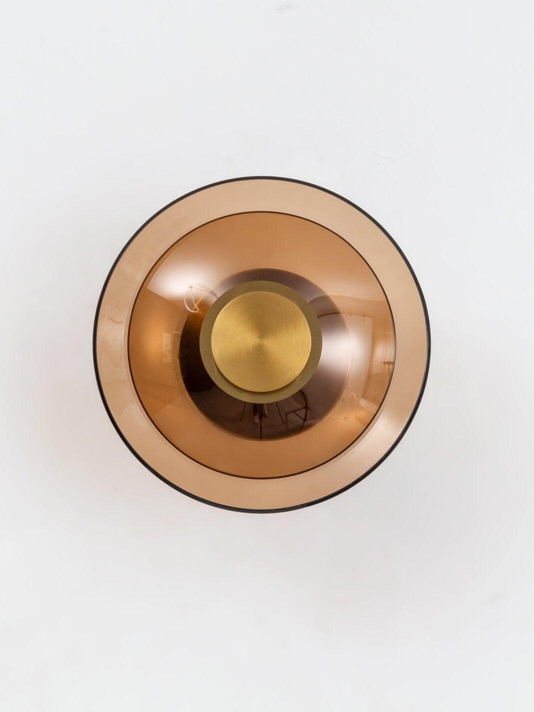 Front view of amber glass disc with gold circular centre
