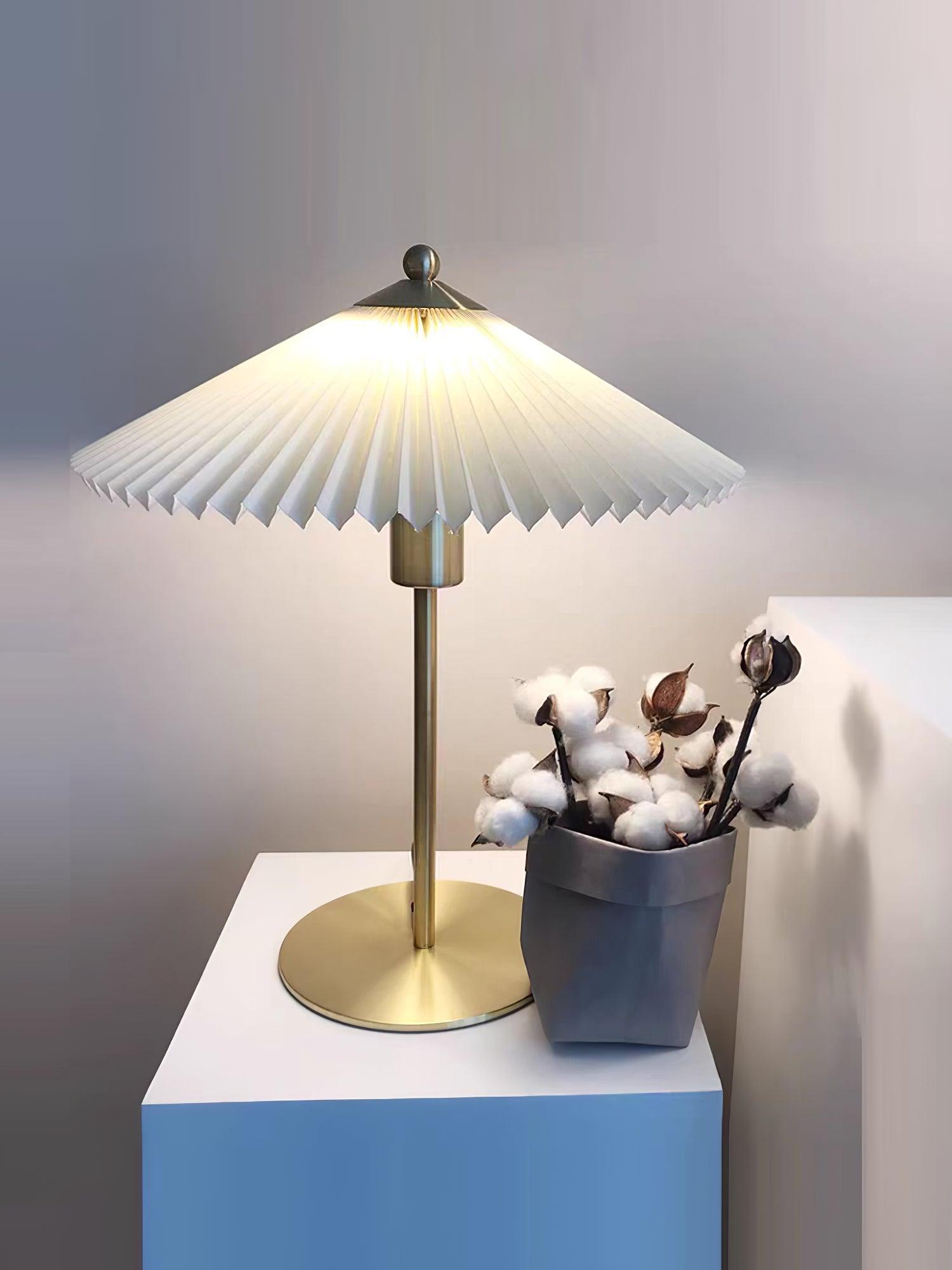 Perla lamp on a white-and-blue cabinet beside a pot of cotton stems