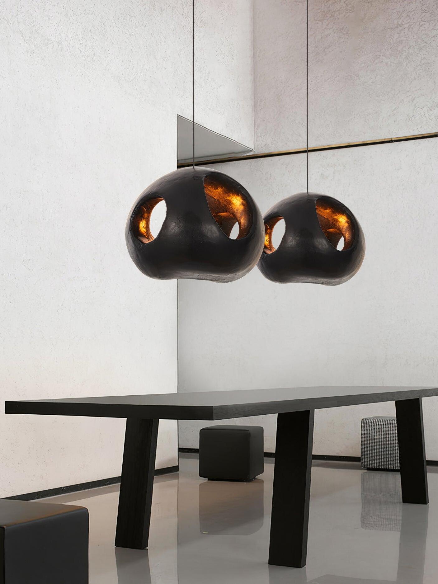 Two black Makivka pendants over a dining table