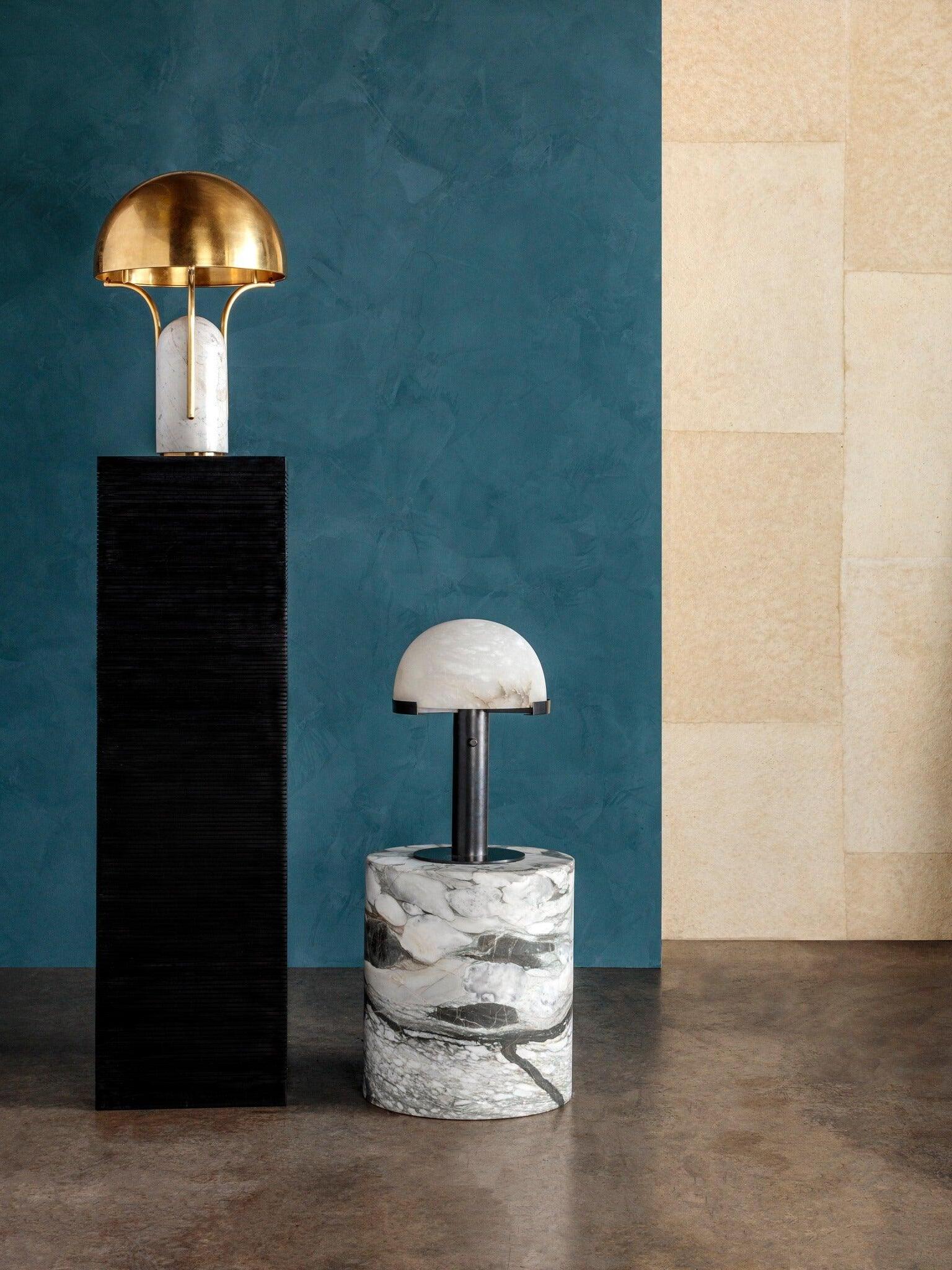 Two different table lamps on display pedestals