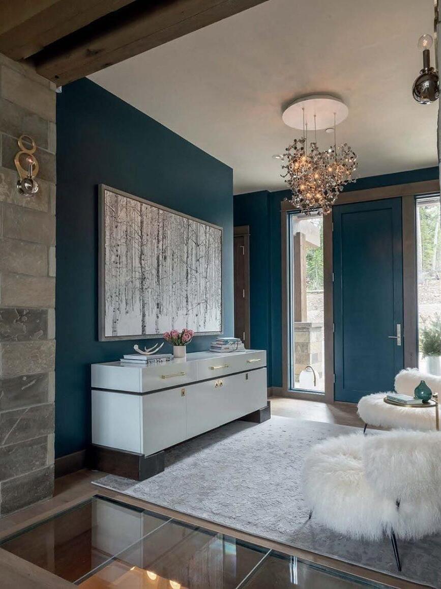 Gold disc cluster near teal wall and pale cabinet