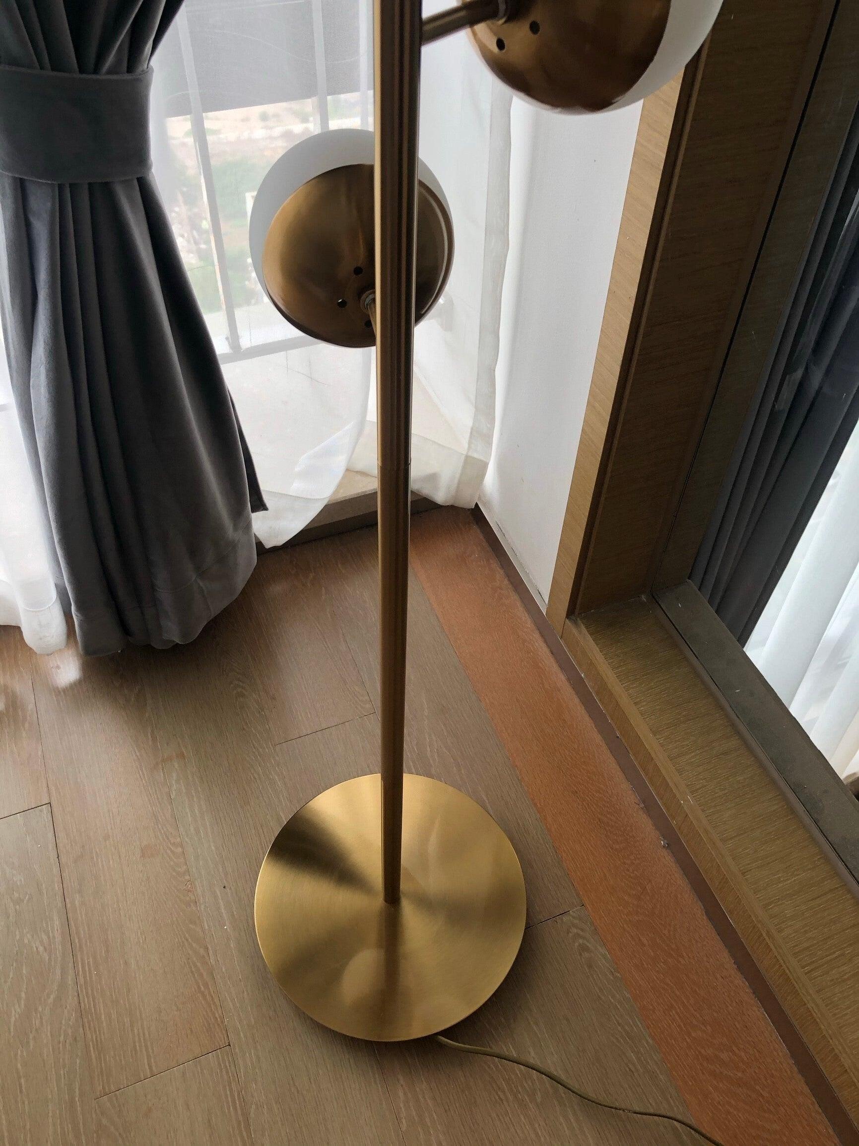 Close view of round gold floor base and cord