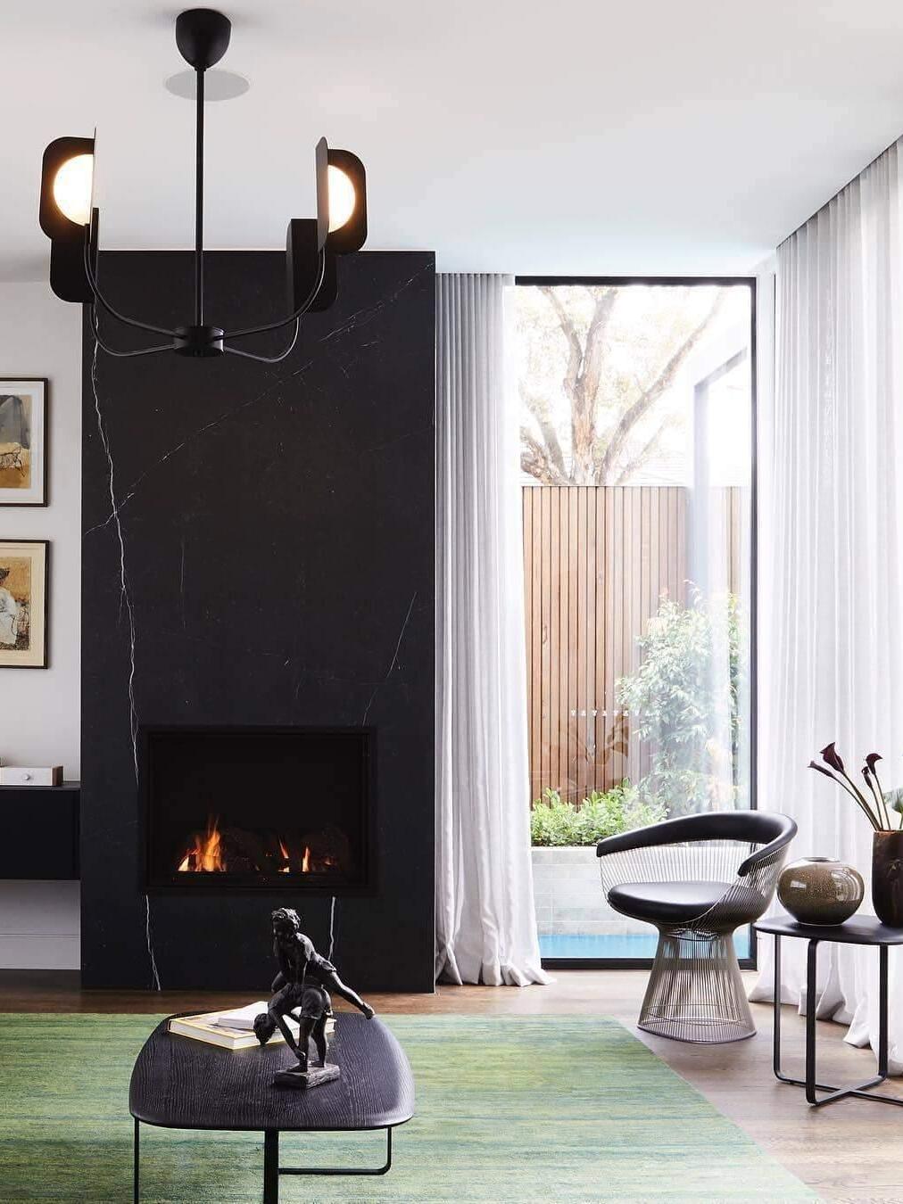 Small black LEAF chandelier in a tall living room