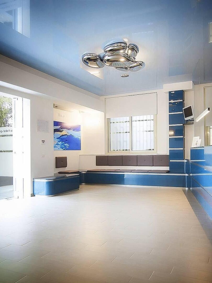 Reflective ceiling cluster in blue-and-white room with window and built-in seating