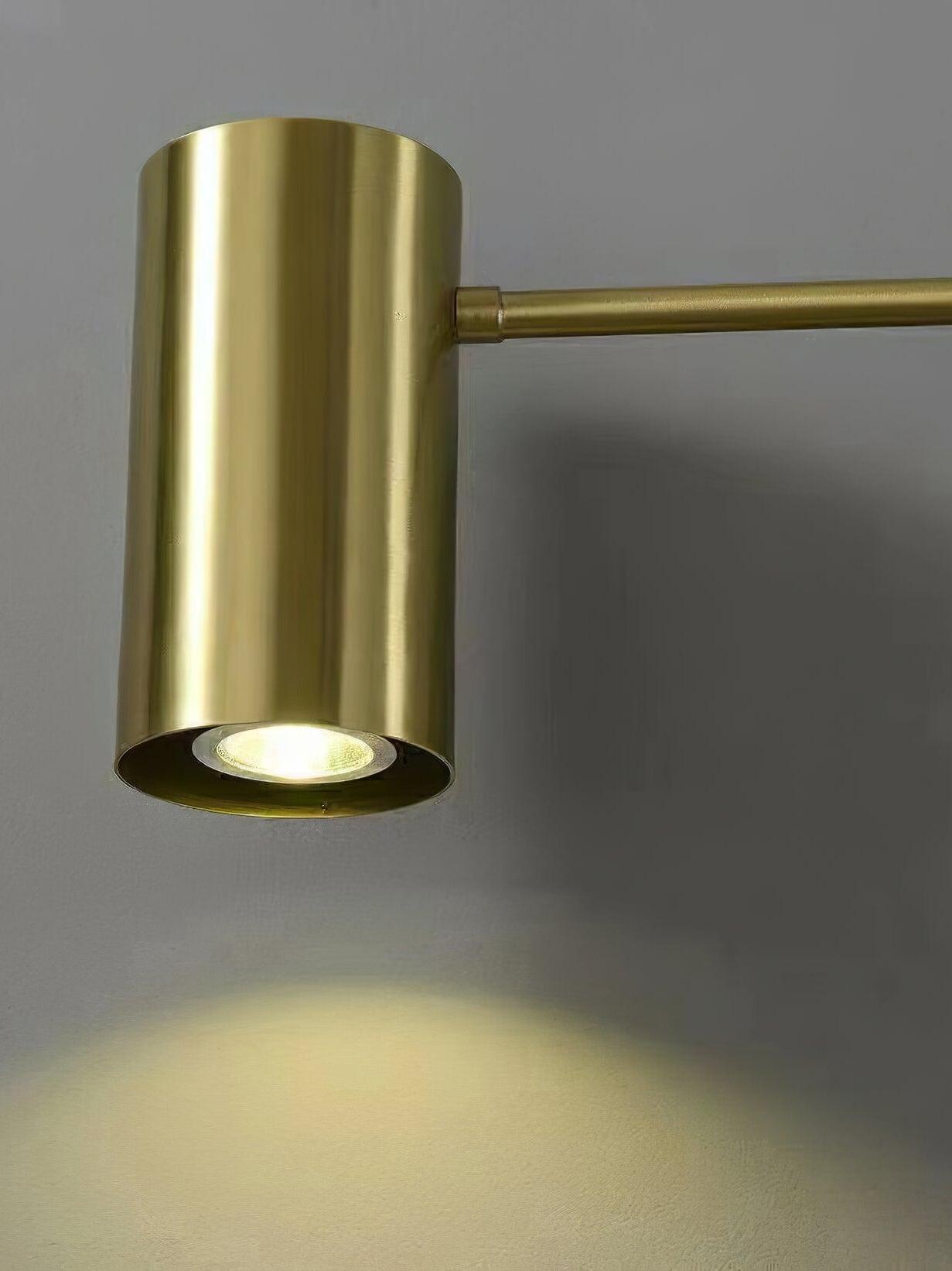 Illuminated circular bulb face inside brass-tone cylinder shade