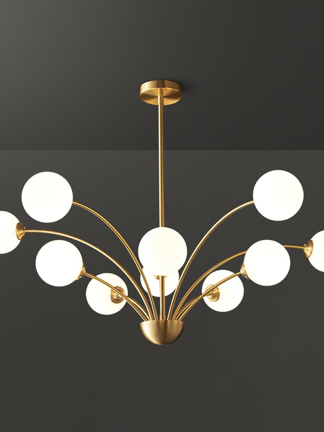 White-globe chandelier with an additional central front globe and curved brass-tone arms on a dark background