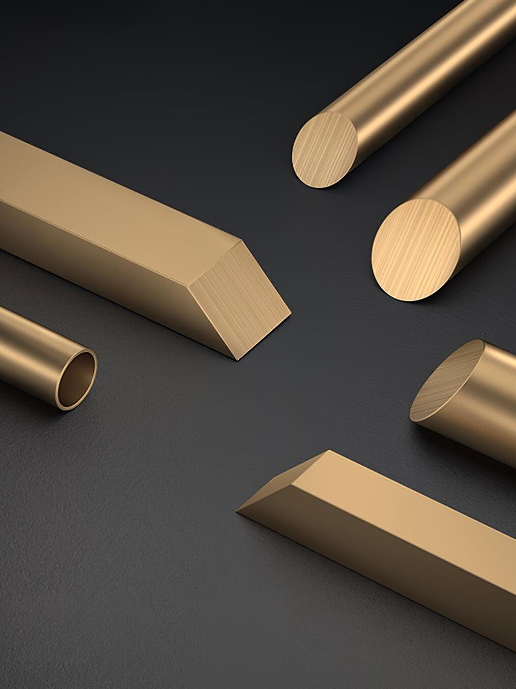 Stock material photograph of brass-colour metal bars, cylindrical rods and hollow tubing