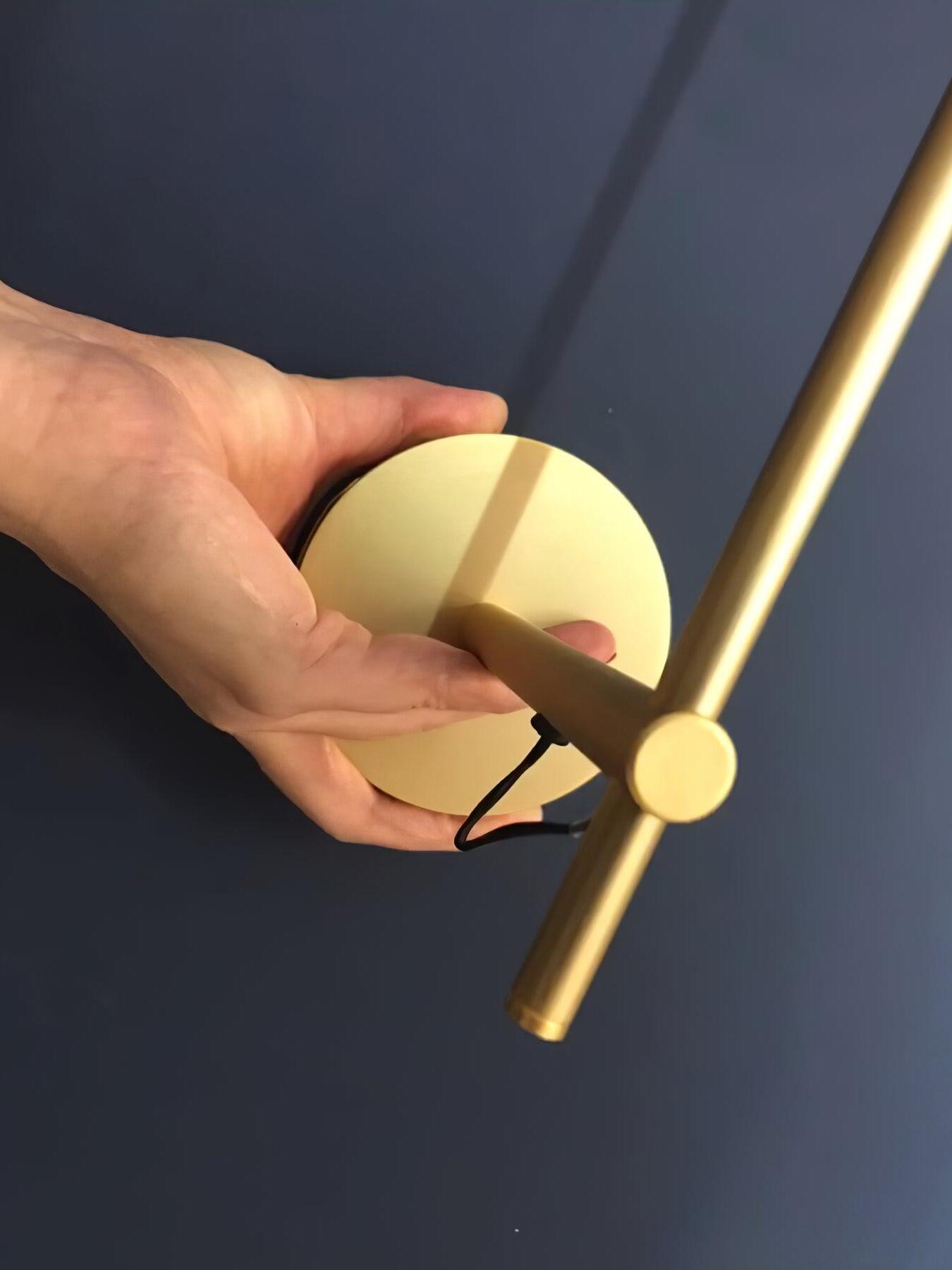 Close view of round Gold plate, arm and wire near the joint