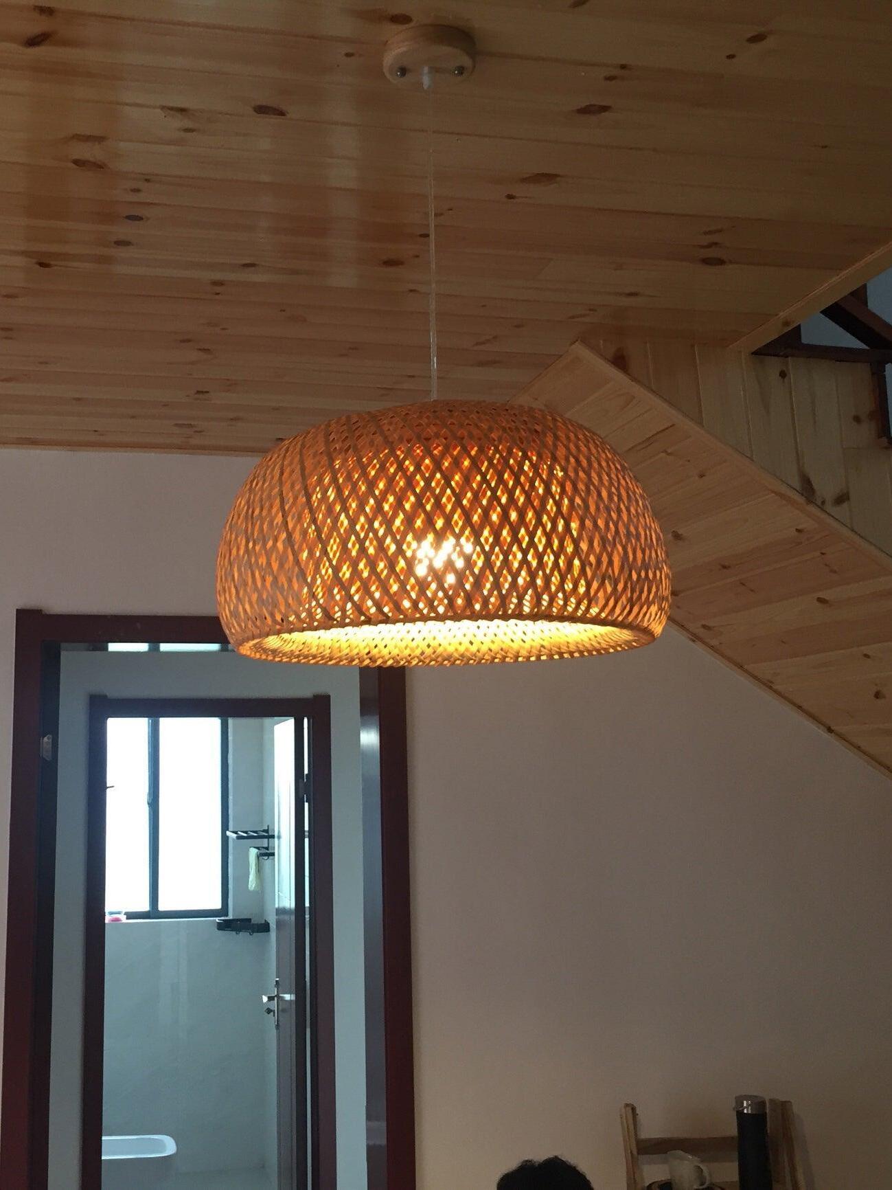 Lit woven dome beneath timber ceiling