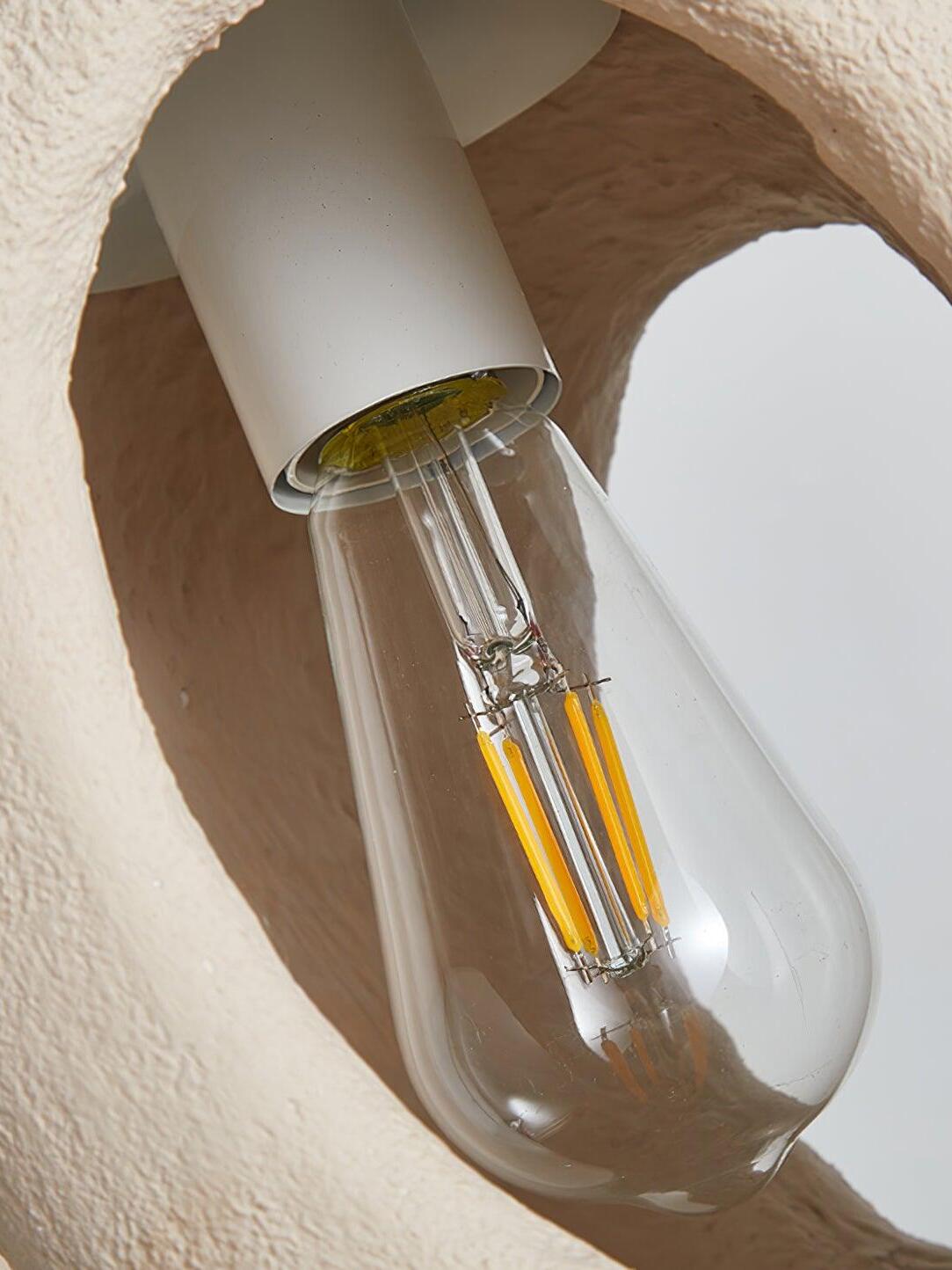 Interior close-up showing a White cylindrical holder and clear pear-shaped bulb with Yellow strips through a body opening