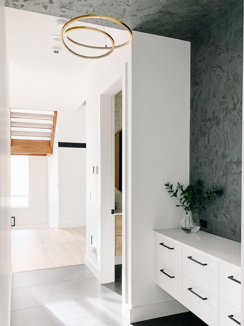 Gold loop light near a staircase and entry area