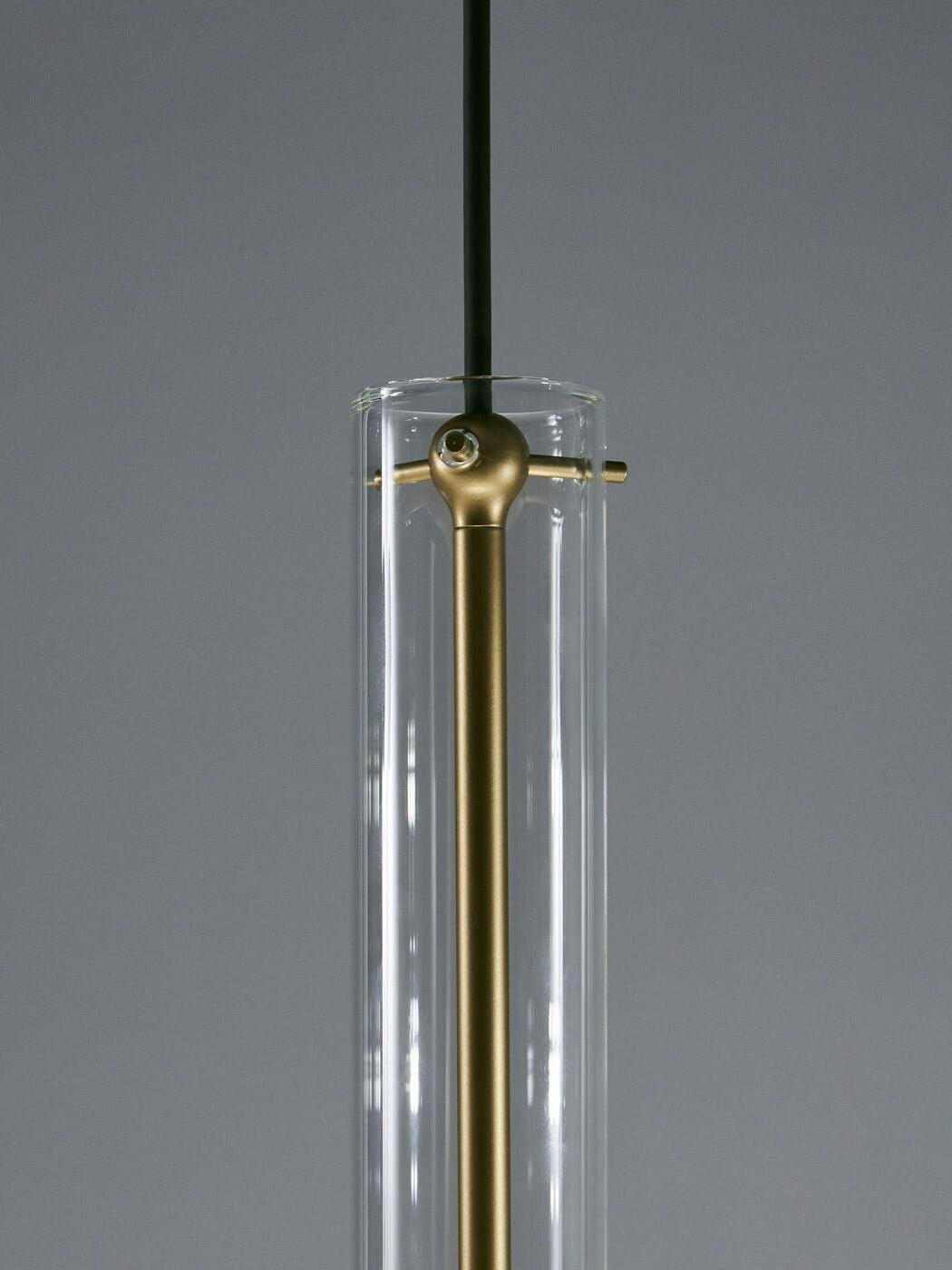 Clear glass upper rim with gold-tone central stem, round top fitting, cross pins and black suspension cable