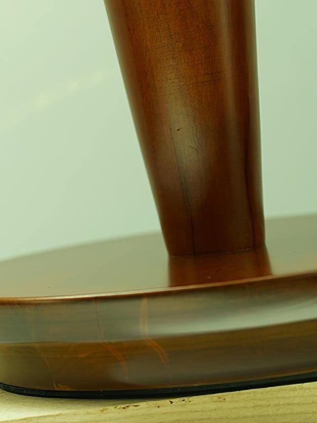 Close view of brown tapered stem and round foot