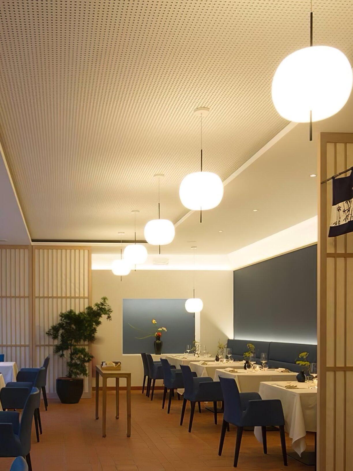 White pendant lights along a restaurant interior