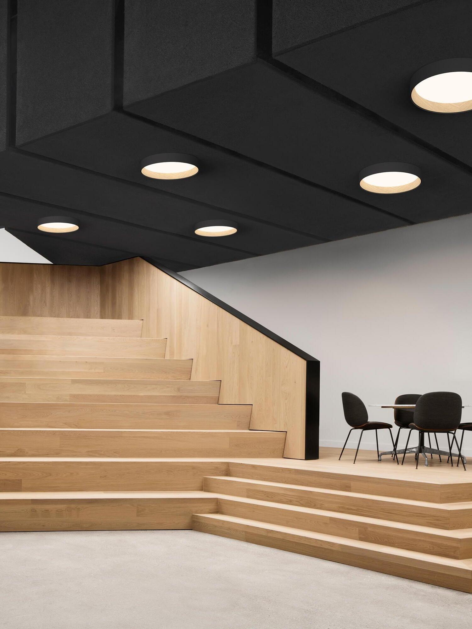 Small black round ceiling lights above stairs