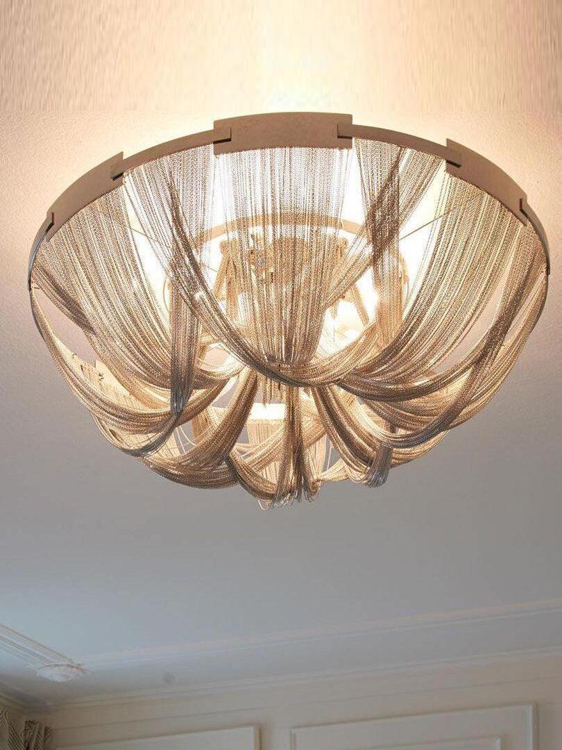 Gold-tone chain loops around visible light bulbs