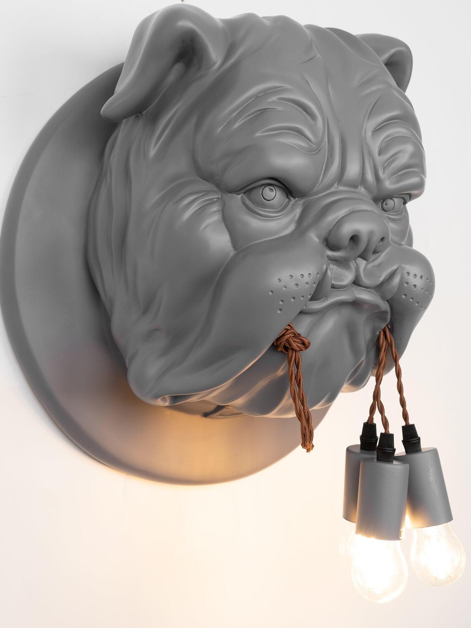 Grey bulldog sconce with brown cords and lit bulbs