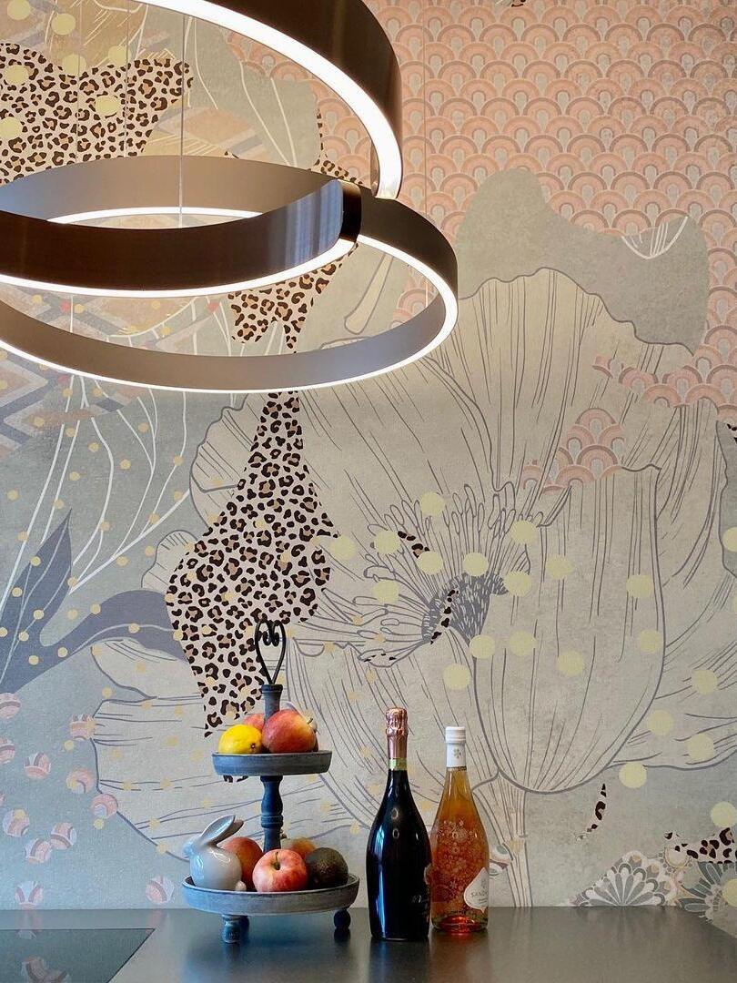 Close view of metallic rings near patterned wallpaper