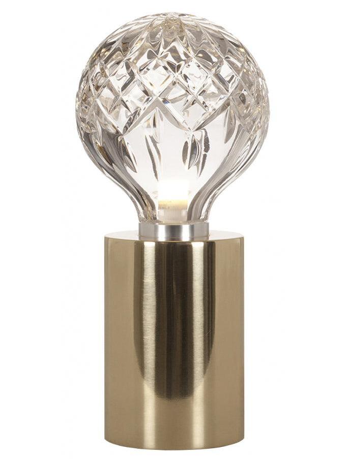 Isolated clear patterned bulb-shaped globe on polished gold-tone base