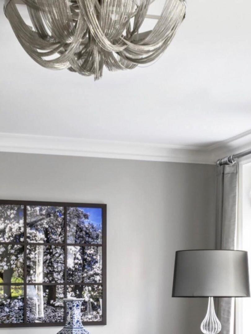 Silver chain ceiling fixture over grey living room