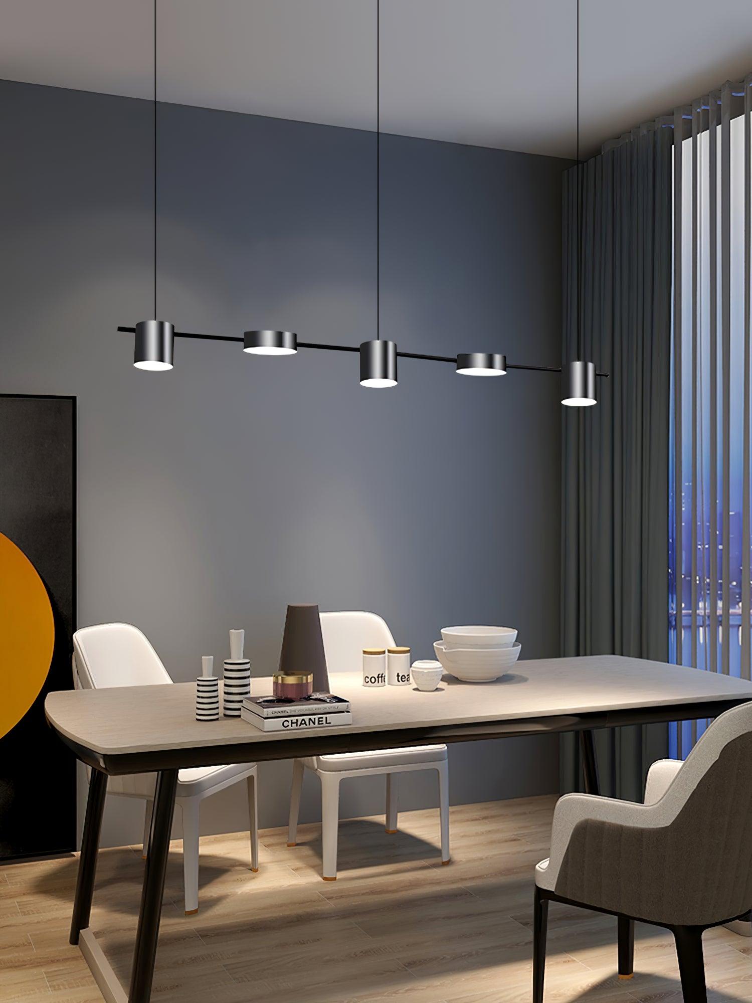Black linear fixture above a table set for dining