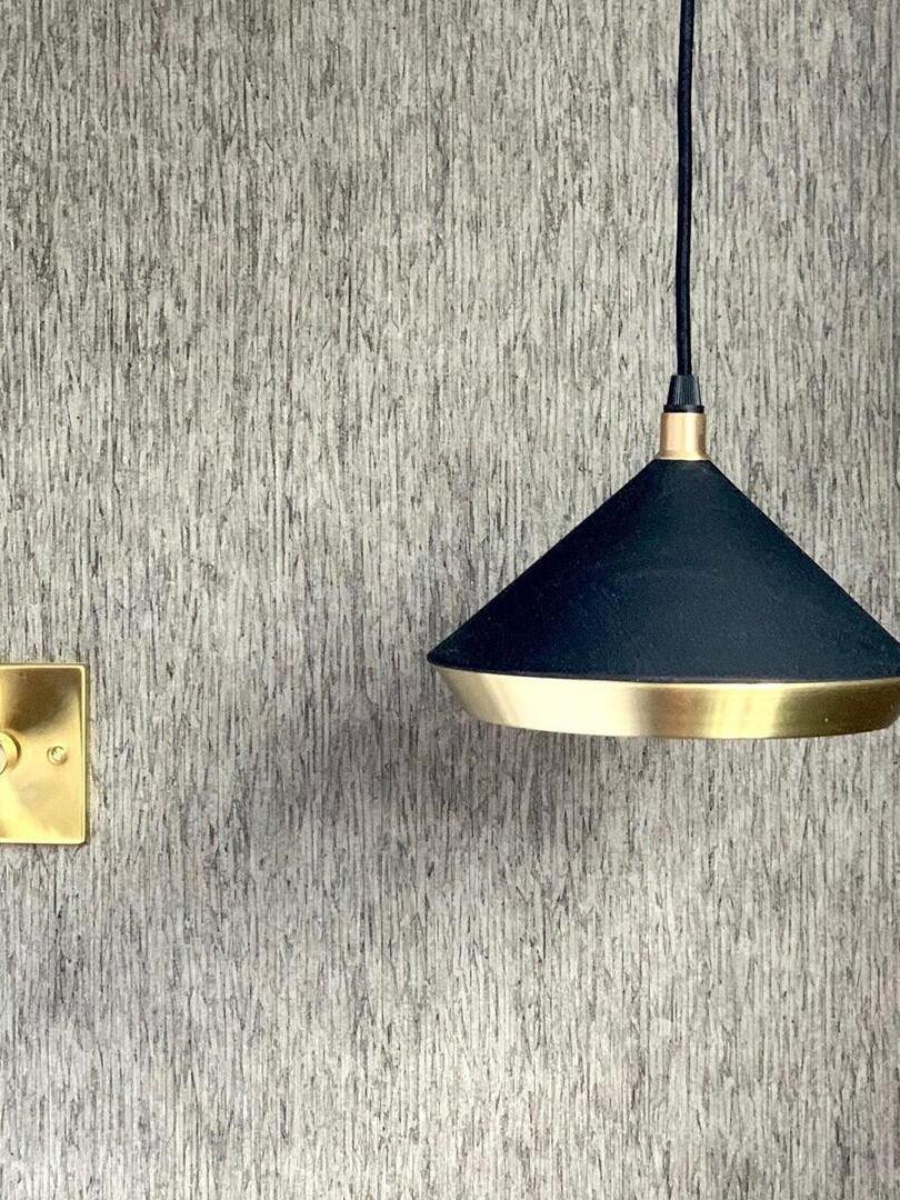 Matte Black cone pendant against a textured wall