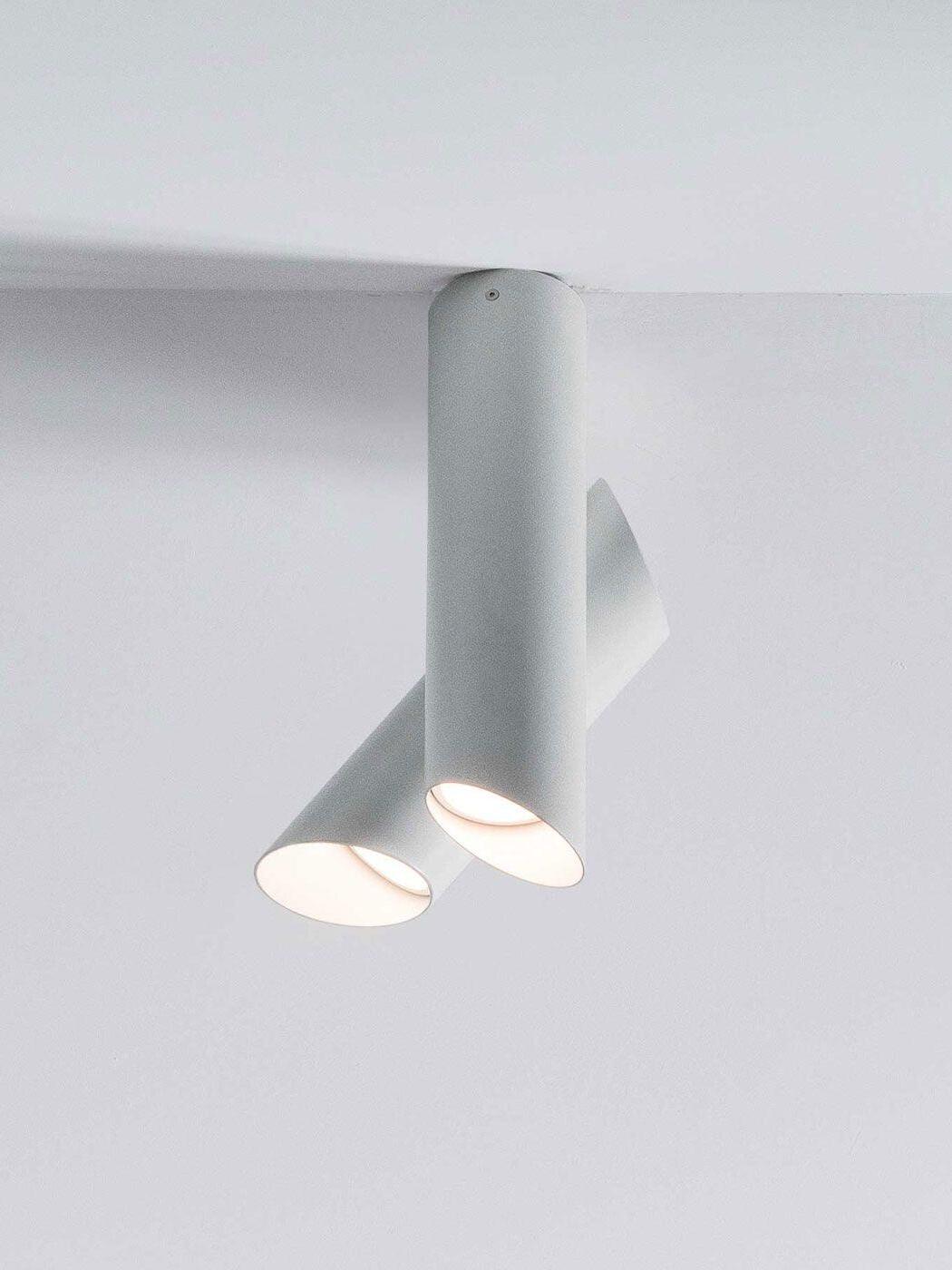 White Tubes fixture mounted on a ceiling with both circular light openings illuminated