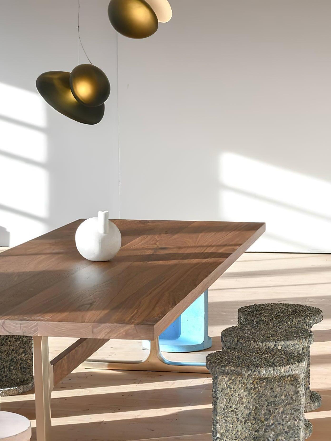 Amber and pale pebble pendant over a wooden table