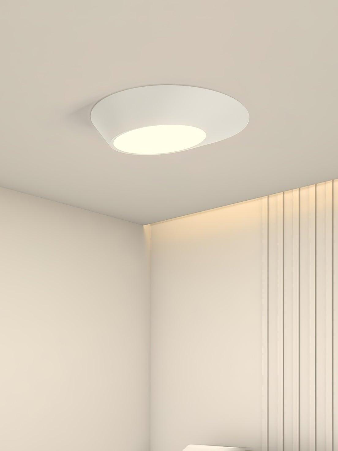 White angled ceiling light beside vertical wall slats in a pale bedroom corner
