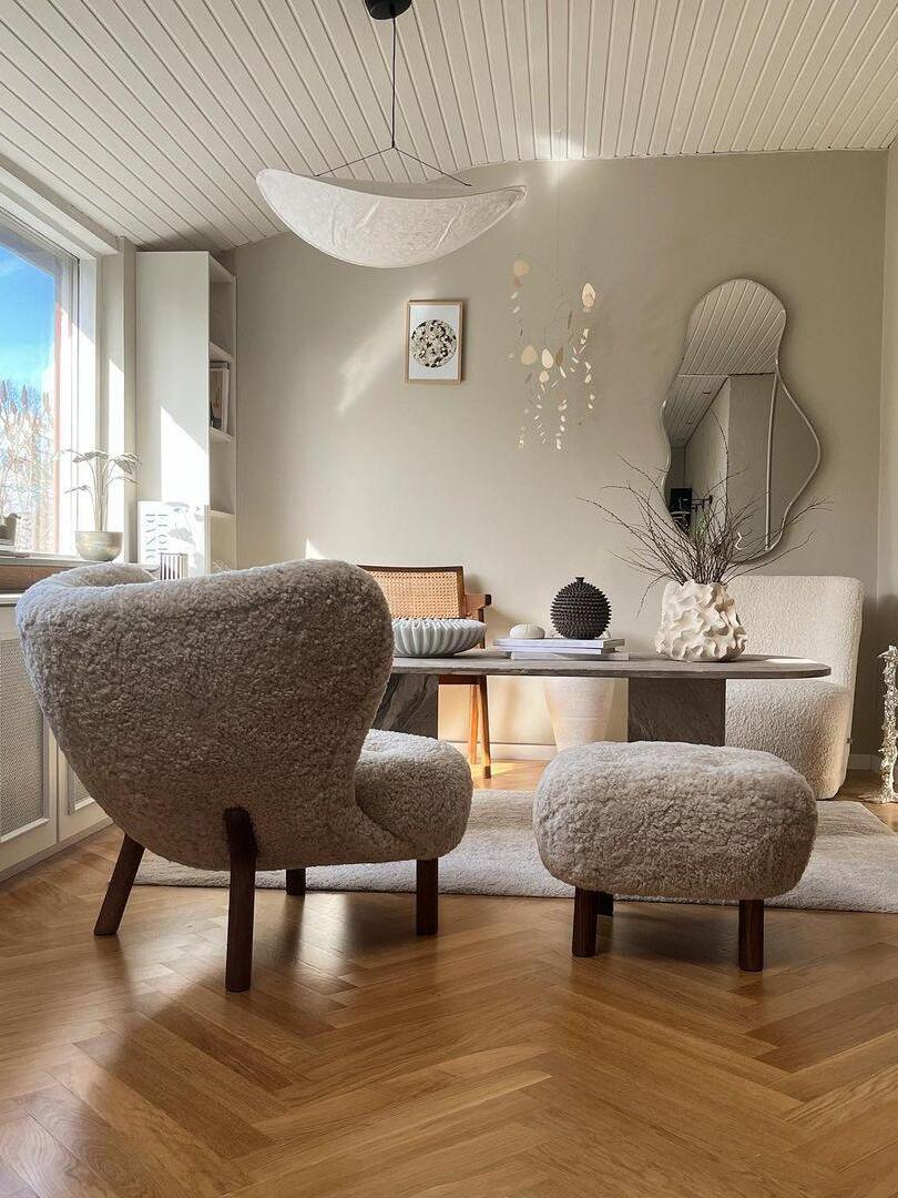 Cloud-like pendant above upholstered chairs