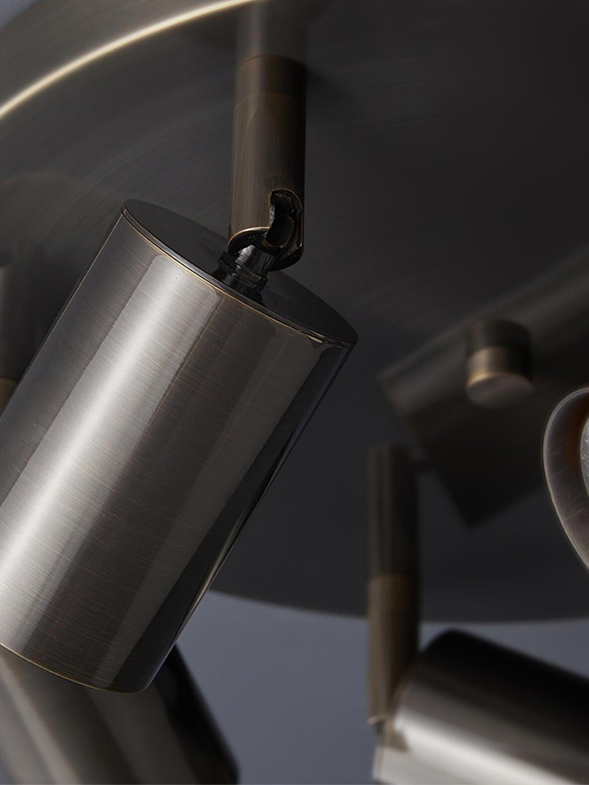 Close black cylindrical spotlight head beneath ceiling plate