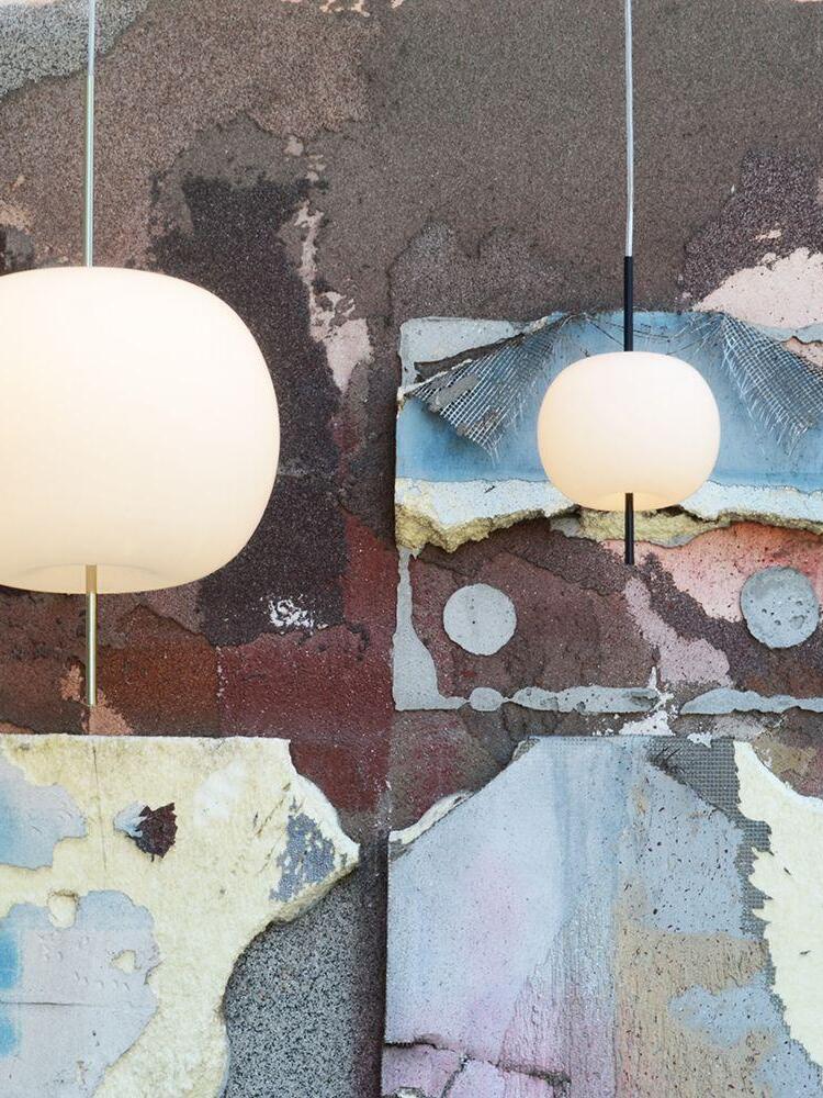 White rounded pendant beside a textured wall
