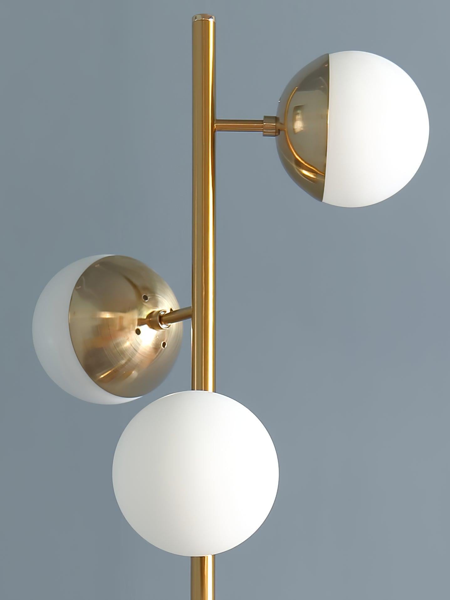 Close view of white globes and gold cup holders