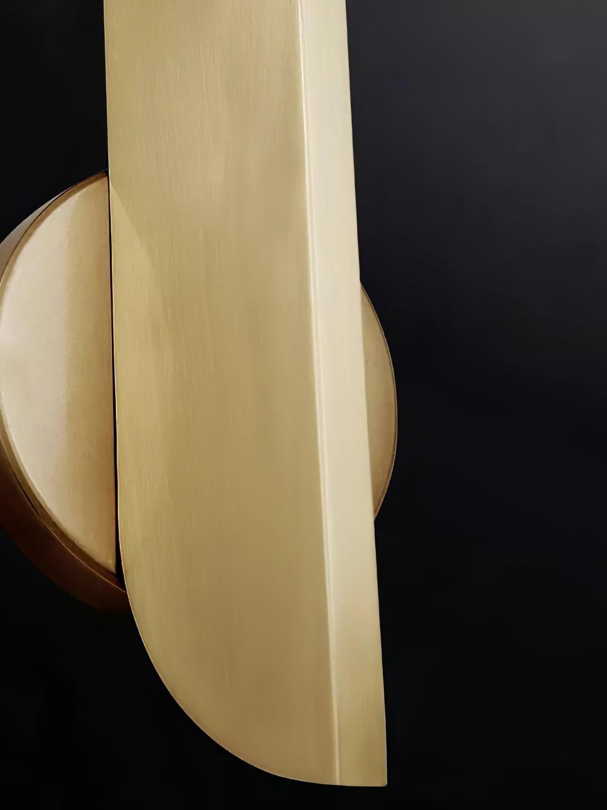 Close view of the rounded gold-colour blade end and circular wall plate with side screw aperture
