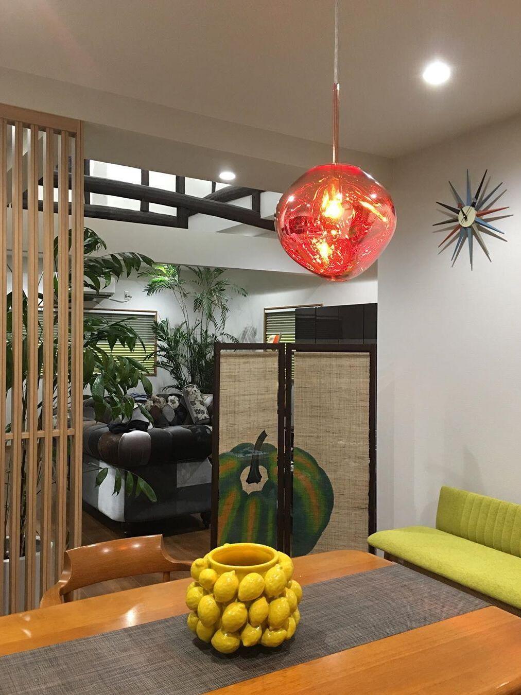 Single red-orange pendant above a table
