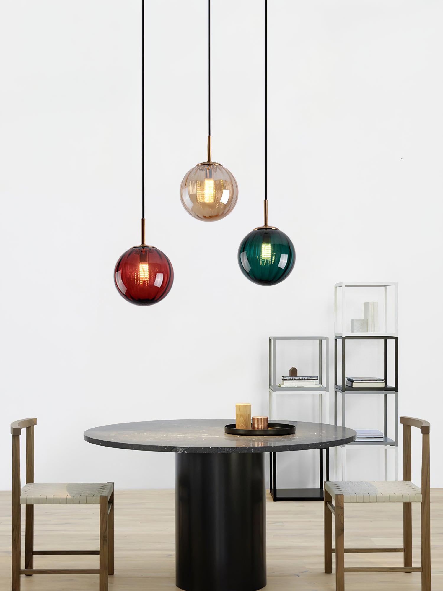 Three coloured globes arranged above a table